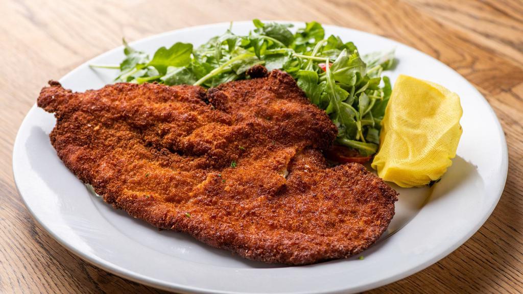 Cotoletta Di Pollo Alla Milanese · Pan fried chicken breast milanese style served with arugula and marinated cherry tomatoes.