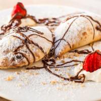 Calzone Alla Nutella · Two small calzones filled with ricotta cheese and nutella.