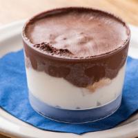 Profiteroles · Three cream puffs surrounded by vanilla and chocolate cream.
