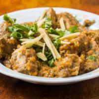 Lamb Or Goat Curry · Pieces of lamb or goat gently cooked in a thick sauce.