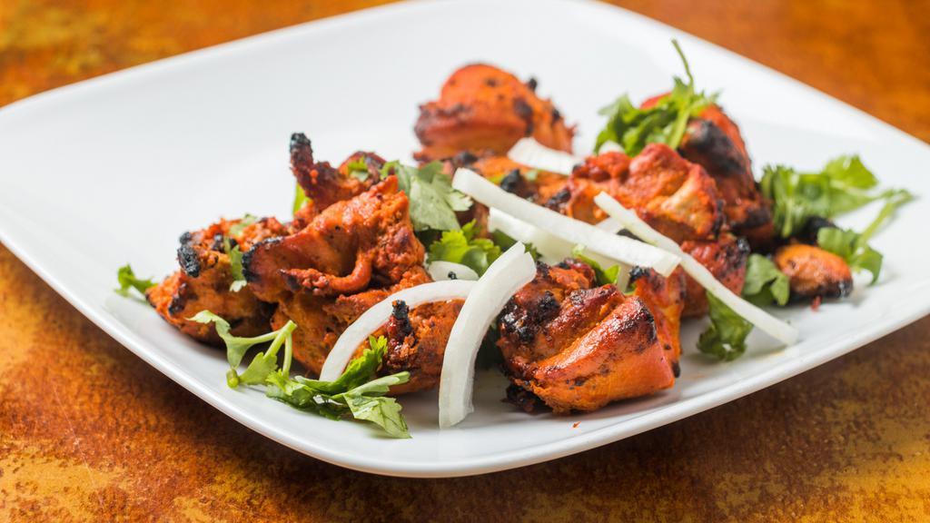 Chicken Tikka Boneless · With bone chicken pieces marinated with yogurt and spices and broiled in a oven.
