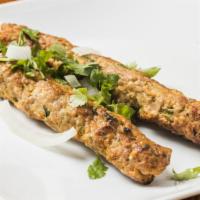 Chicken Seekh Kabab · Minced chicken kabab seasoned with onion, spices and herbs and barbecued in a clay oven.