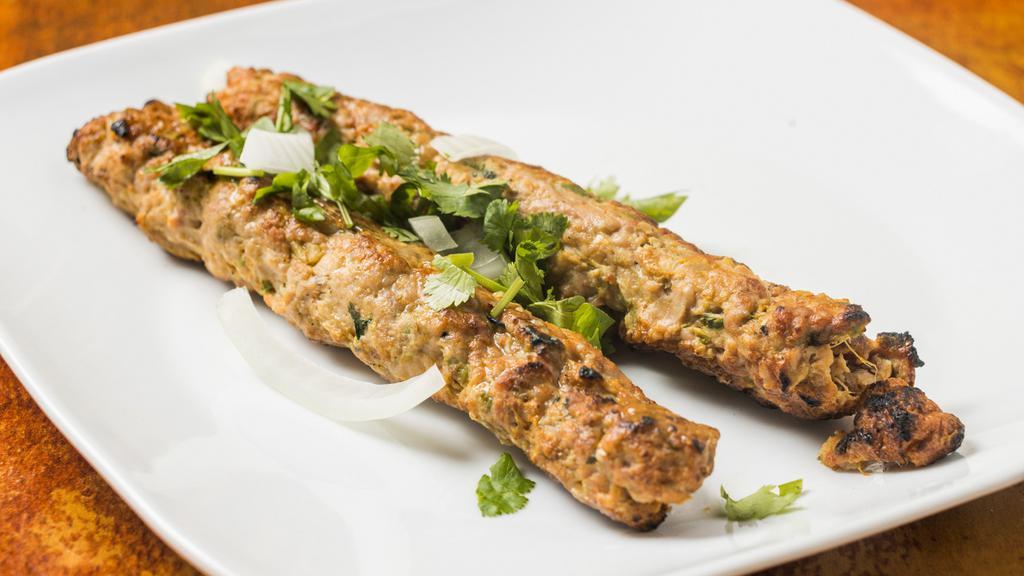 Chicken Seekh Kabab · Minced chicken kabab seasoned with onion, spices and herbs and barbecued in a clay oven.