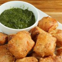 Lazeez Paneer Pakora · Golden crisp batter fried Indian Cottage cheese with touch of paprika.