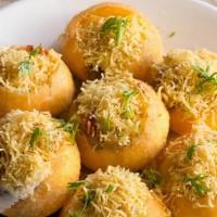 Bombay Sev Batata Puri · Crisp puri topped with potatoes, onions, gram flour sev, spicy and sweet chutney.