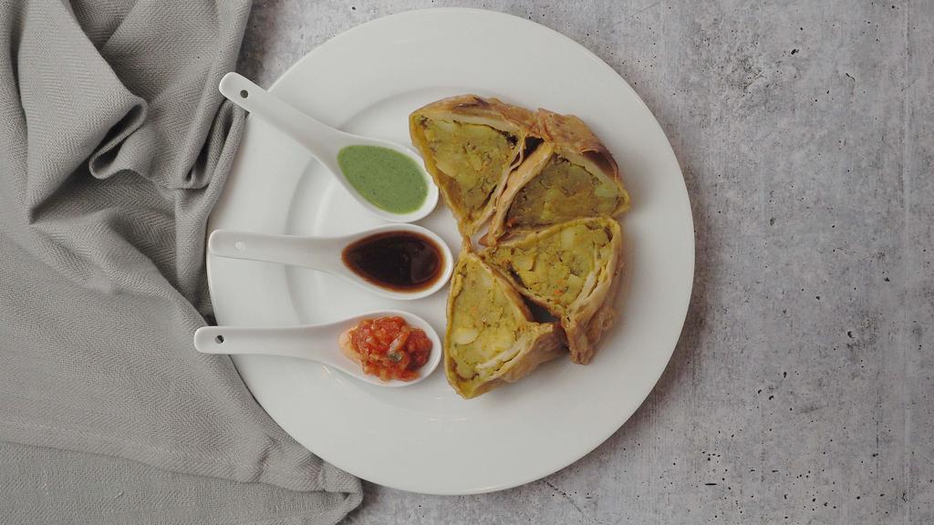 Vegetable Samosa ( 2 Nos) · Crispy pastry stuffed with mildly spiced potatoes and peas.