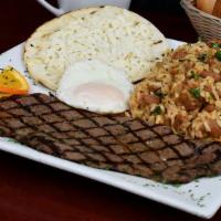 Calentado · Rice-beans mix with egg, cheese topped arepa and steak, grilled chicken or pork sausage