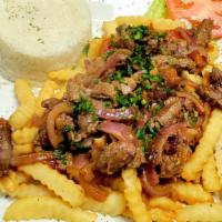 Lomo Salteado · Sautéed beef with onions and tomatoes, served over fries and rice.