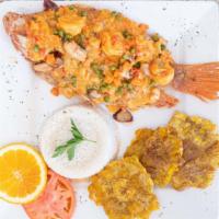 Pargo Marinado · Red snapper topped with seafood creamy sauce.