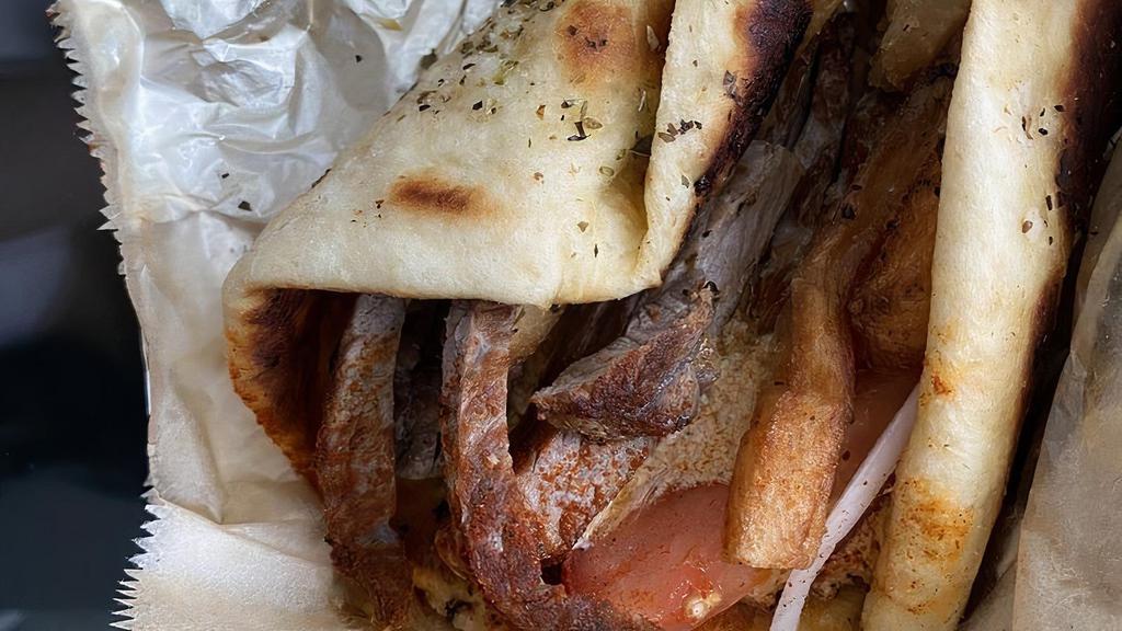 Pita Steak · NY strip, tomato, red onions, fries, paprika, tyrokafteri.
