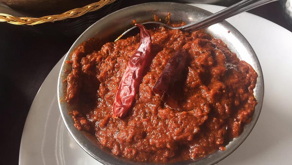Chicken Vindaloo · Very spicy. Fiery sauce, sun dried Kashmiri red chili, potato, tamarind. Served with Basmati rice.
