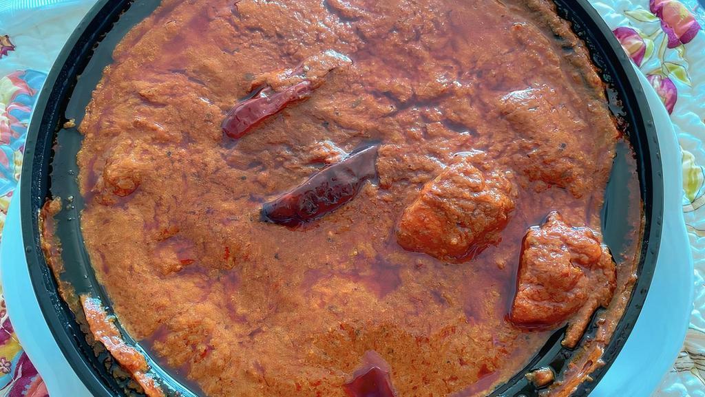 Lamb Vindaloo · Very spicy. Fiery sauce, sun dried Kashmiri red chili, potato, tamarind. Served with Basmati rice.