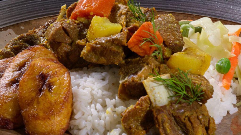 Curried Goat - Side Only · Tender chunks of curry-clad goat cooked to the bone. Includes potatoes and carrots for a hearty anytime meal. Perfect with white rice.