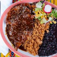 Chicken Mole Platter · Grilled Chicken breast dressed in mole sauce and sesame seeds served with Mexican rice, blac...