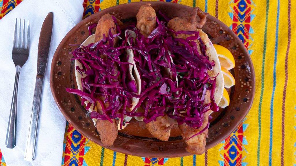 Baja Fish Tacos · Lightly fried beer battered tilapia on a corn tortilla with chipotle mayo and topped with a red cabbage slaw. Three per order.