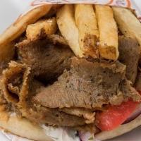 Beef & Lamb Gyro Sandwich (Halal) · beef & lamb gyro slow roasted on a vertical broiler wrapped in pita with tomatoes, onions, t...