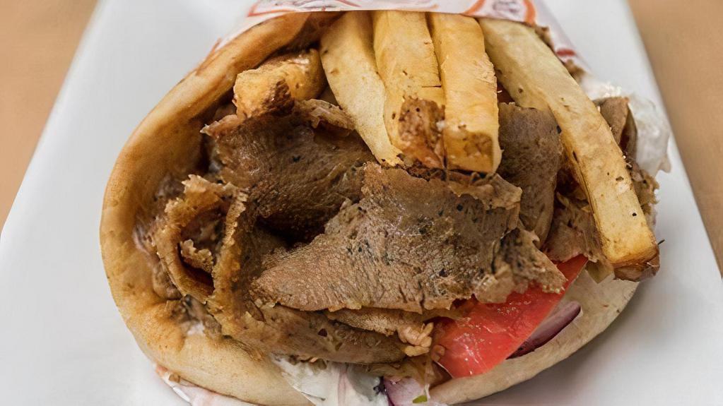 Beef & Lamb Gyro Sandwich (Halal) · beef & lamb gyro slow roasted on a vertical broiler wrapped in pita with tomatoes, onions, tzatziki, topped with fries (E)