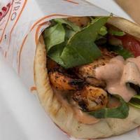 Shrimp Souvlaki Pita · grilled, marinated jumbo shrimps wrapped in pita with tomatoes, lettuce & our pink sauce