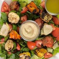Mediterranean Salad · Romaine Lettuce, Hummus, Grilled Veggies, Tomatoes, served with pita bread and your salad dr...