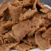 Beef & Lamb Gyro Meat (Halal) · side of beef & lamb gyro slow roasted on a vertical broiler (D,E)