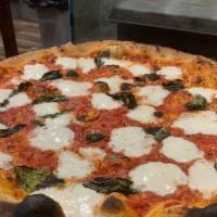 Margherita · Homemade mozzarella, basil, tomato sauce, extra virgin, olive oil & Parmesan cheese