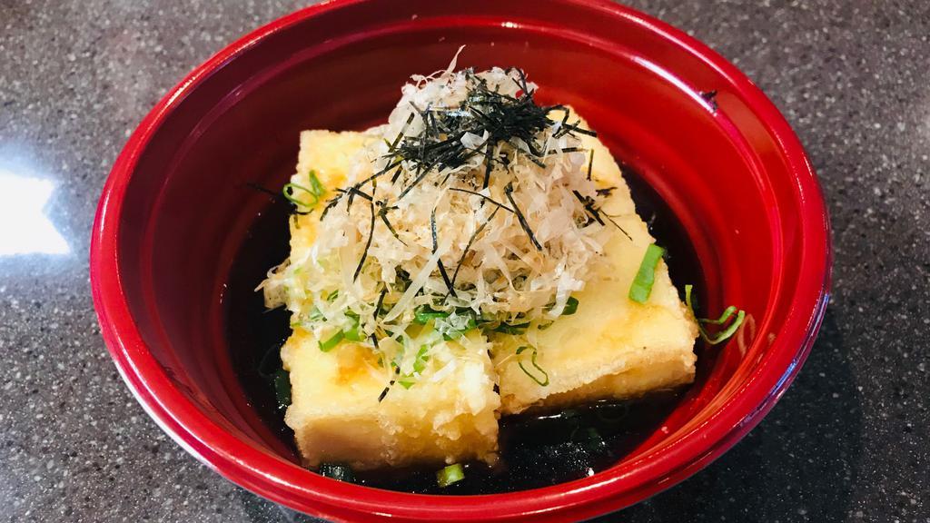 Agedashi Tofu 揚げ出し豆腐 · Deep fried Tofu. Crispy deep fried tofu served in flavorful tsuyu sauce with grated radish, green onion, and bonito flakes as toppings.
*Tsuyu- sauce -home made from all natural ingredients.