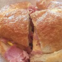 Breakfast Croissant Sandwich · Meat of choice (bacon  or ham), egg and American cheese.