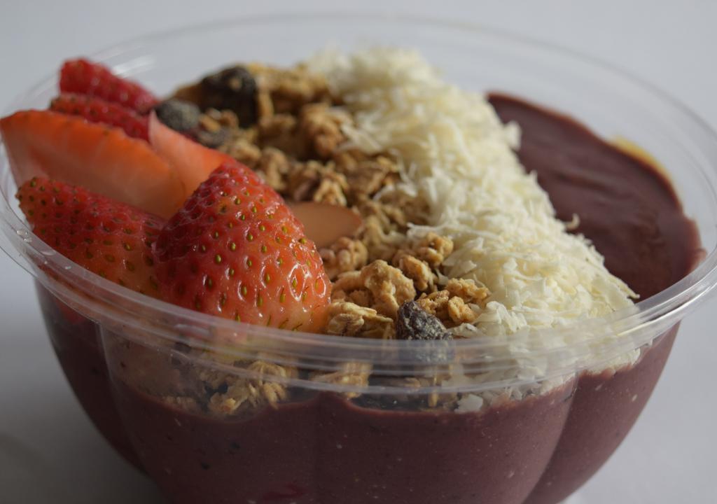 Açaí · Açaí, strawberry, blueberries blend topped with granola, coconut flakes, strawberries and honey.