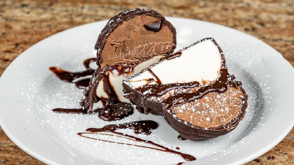 Coco Tartufo · Vanilla and chocolate ice cream with raspberry nut jam in center enrobed in dark chocolate.