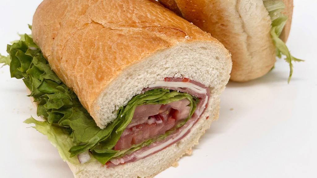 Italian Hero · Genoa salami, hot capicola, provolone cheese, tomatoes, Green Leaf lettuce, hot chopped peppers, red onions, olive oil, red wine vinegar and oregano on a hero roll.
