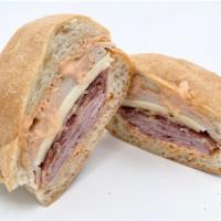 Club Panini · House Roasted Turkey, Boiled Ham, Bacon, Swiss Cheese, 1000 Island Dressing on Ciabatta Bread.