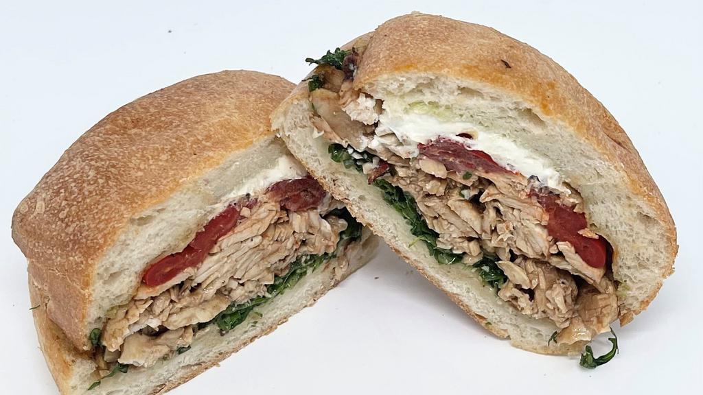 Grilled Chicken & Goat Cheese · Balsamic Grilled Chicken Breast, Roasted Red Peppers, Goat Cheese, Arugula, Herb Mayonnaise on Ciabatta Roll.
