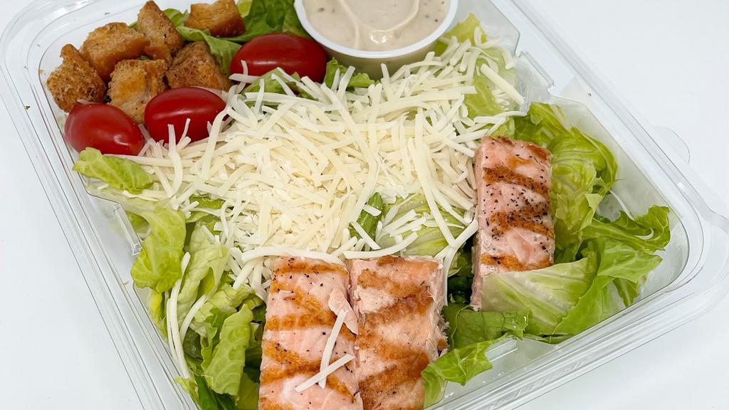 Grilled Salmon Caesar Salad · Grilled Salmon, Shredded Parmesan, Grape Tomatoes, Croutons over Romaine Lettuce with Caesar Dressing.