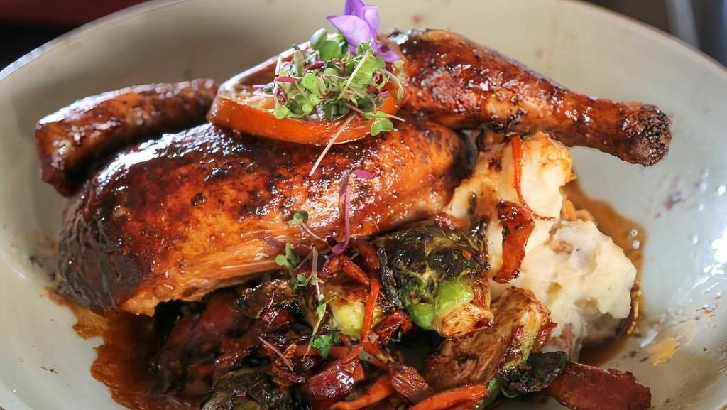 Brick Chicken · ½ bone-in free range chicken, homemade mashed potatoes, Brussels sprouts, smoked slab bacon, chicken jus