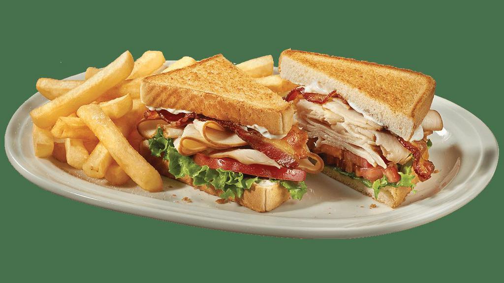 Turkey Blt · Hand-carved turkey breast, applewood-smoked bacon, lettuce, tomato and mayo on toasty white bread. Served with golden fries.