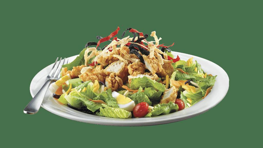 Crispy Chicken Salad · Crispy chicken tenders with Monterey Jack & Cheddar cheese, fresh tomatoes, sliced egg, colorful tortilla strips, and mixed greens. Recommended with Honey Mustard dressing.