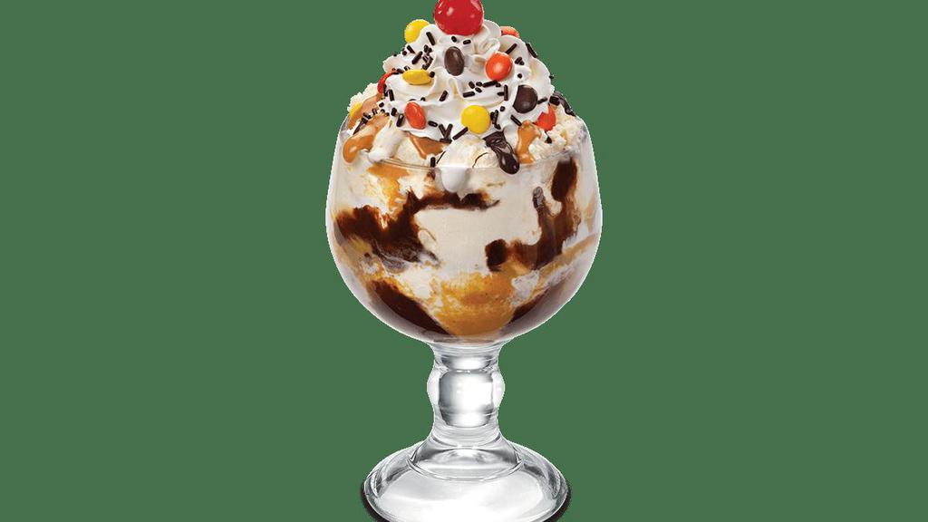 Reese'S® Pieces® Sundae · Vanilla ice cream, savory peanut butter topping, fluffy marshmallow, hot fudge, chocolate sprinkles and REESE’S PIECES.