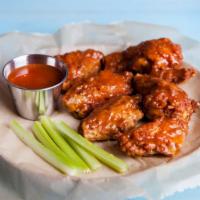 Sweet Chili Wings · Golden, crispy, deep-fried wings, glazed with sweet and spicy chili sauce. Add on a dipping ...