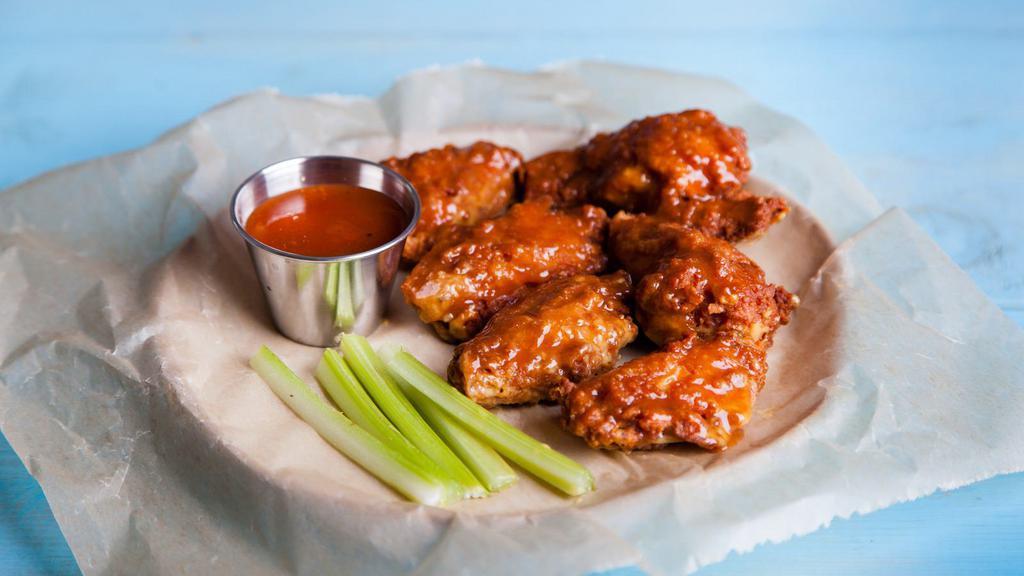Sweet Chili Wings · Golden, crispy, deep-fried wings, glazed with sweet and spicy chili sauce. Add on a dipping sauce and side!