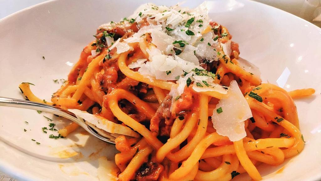 Fusilli Bolognese · Fusilli Pasta, Peas, Parmigiano Cheese & Fresh Basil Topped with a Homemade Meat Sauce.