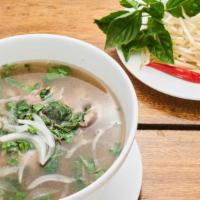 Pho Bo Hanoi Soup · With rice noodles, thin slices of beef, julienne scallions, and onions in a slow simmered an...