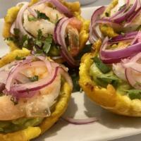 Tostones Latitud · 4 Fried green plantain with guacamole and shrimp.