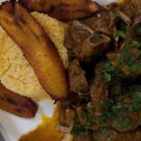Seco De Chivo · Goat stew, rice, sweet plantain, and avocado.