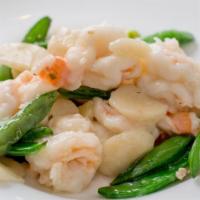 Quick Sauteed Prawns Beijing Style · Large prawns marinated in egg whites and sauteed in rice wine. Garnished with sugar snap pea...