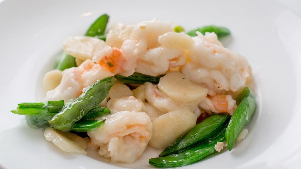 Quick Sauteed Prawns Beijing Style · Large prawns marinated in egg whites and sauteed in rice wine. Garnished with sugar snap peas and fresh water chestnuts.