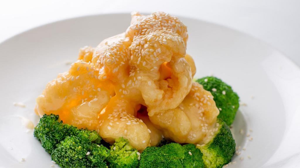 Grand Marnier Prawns · Jumbo prawns coated with water chestnut flour, fried until crispy, then sauteed in a Grand Marnier sauce. Served with broccoli and sesame seeds.