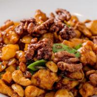 Chicken With Three Different Nuts · Chicken breast garnished with water chestnuts, bamboo shoots and snow peas, cooked in a brow...