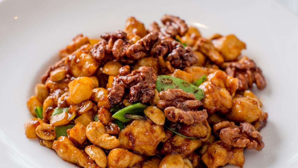 Chicken With Three Different Nuts · Chicken breast garnished with water chestnuts, bamboo shoots and snow peas, cooked in a brown sauce with sauteed walnut peanuts and cashews nuts.