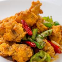Three Pepper Chicken · Extra hot and spicy. Chunks of crispy chicken sautéed with szechuan hot pepper, garlic and s...