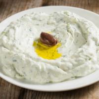Tzatziki · Greek yogurt dip prepared with fresh cucumber, dill, and garlic.